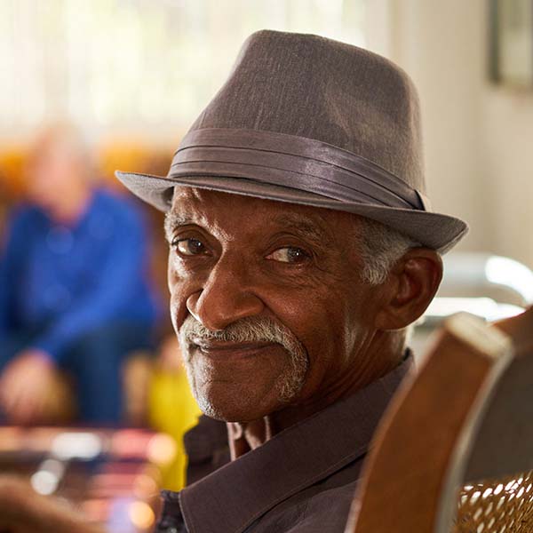close up of older man wearing fedora