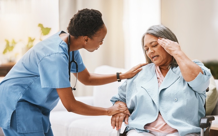 A doctor providing pain management support to a patient with end-stage illness in Portland, OR 