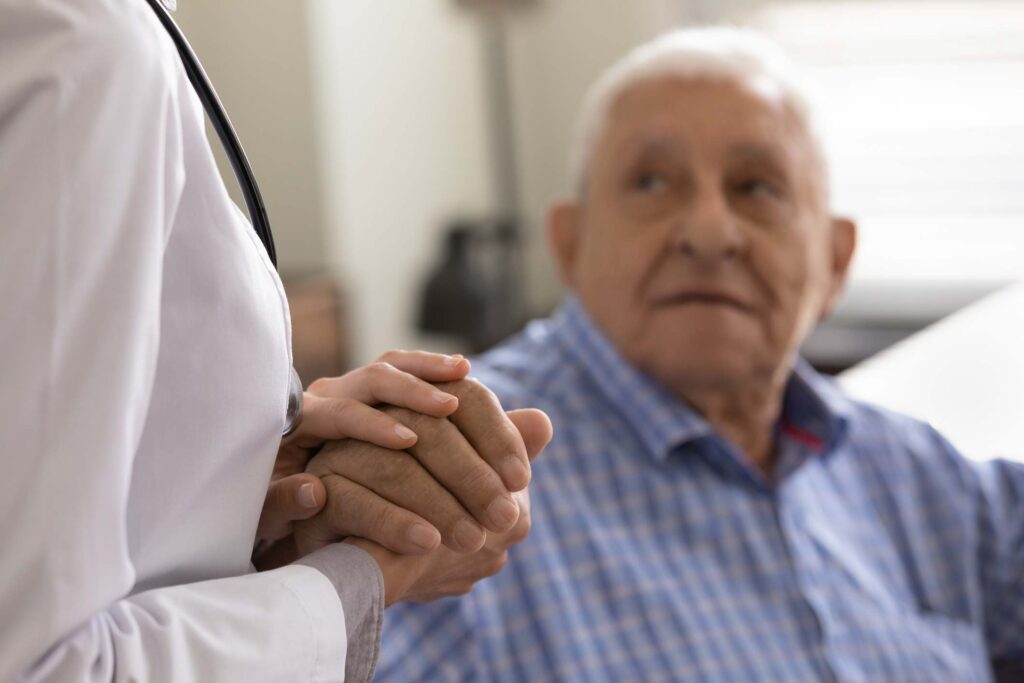 A caregiver giving support to an elderly person during a hospice care discussion in Portland, OR.