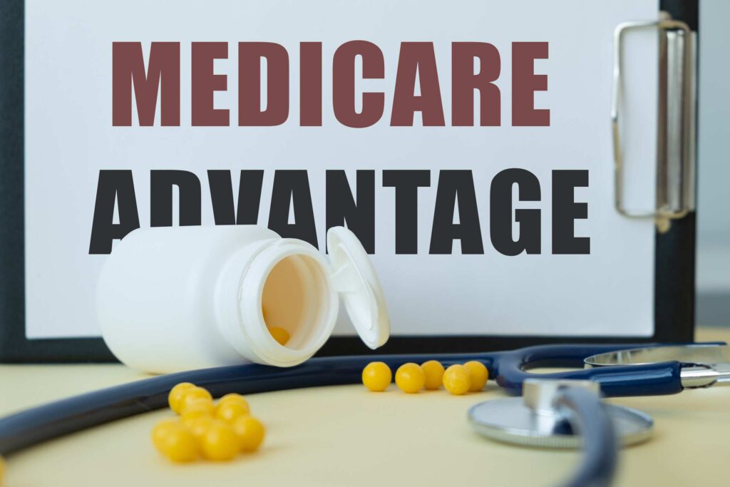 Medical and health concept. Phrase MEDICARE ADVANTAGE written on the business card in a composition with a stethoscope